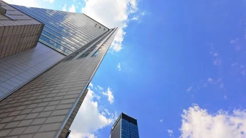 Dynamic urban skyscraper perspective with blue sky and clouds timelapse. Stock Footage 331532932