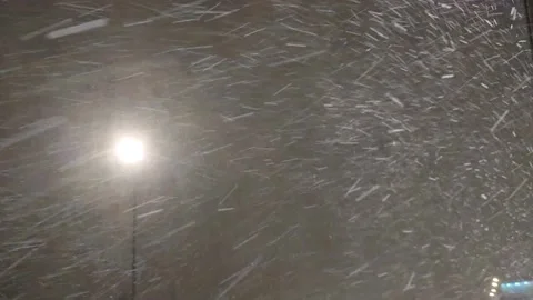 Dynamic video of falling snow in the light of a street lamp. Stock Footage 225544463