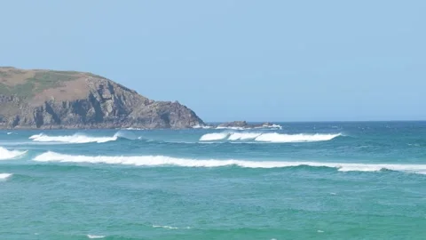 Dynamic video of ocean waves rolling and breaking along the rugged coastline of Stock Footage 346704719