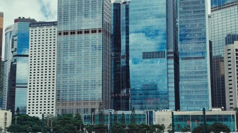 A dynamic view from below on Hong Kong's modern skyline, showcasing both Stock Footage 338311420