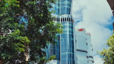 A dynamic view from below of a modern skyscraper in Hong Kong's skyline, framed Video stock 338311527