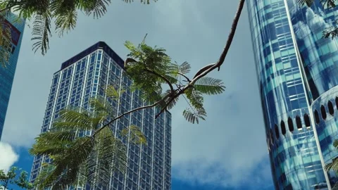 A dynamic view from below showcasing modern skyscrapers against a partly cloudy Stock Footage 338311541