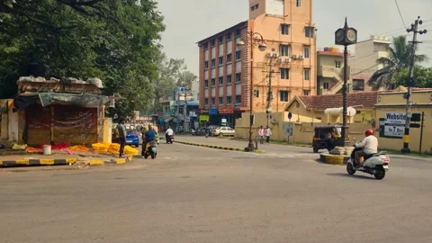 Dynamic view of a busy crossroads in Mysore, India, where cars, motorbikes, and Stock Footage 306284668