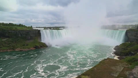 Dynamic view of cascading waters of Niagara Falls, emphasizing powerful mist and Видео 294297643