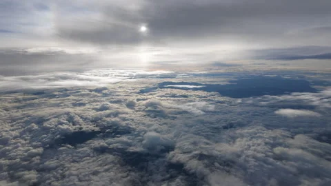 A dynamic view of clouds with the sun peeking through, creating radiant beams Stock Footage 298036041