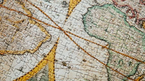 Dynamic view finished puzzle displaying vintage global chart. Jigsaw connected Stock Footage 332310198