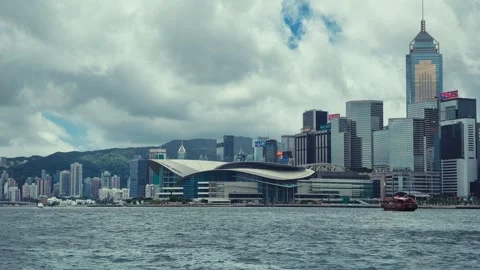 A dynamic view of Hong Kong's iconic skyline from across Victoria Harbour, Stock Footage 338311031