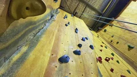 Dynamic View of Indoor Climbing Wall with Colored Holds Stock-Footage 313873203