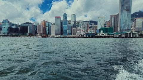 A dynamic view from a moving vessel captures the bustling Hong Kong skyline with Video stock 338311026