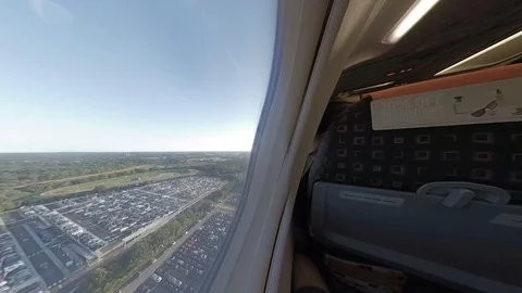Dynamic view onboard plane as it lands passing carparks Stock Footage 118253870
