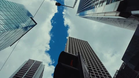 A dynamic view from street level capturing the towering skyscrapers of Hong Stock Footage 338311516
