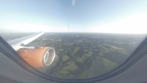 Dynamic view through plane window above British countryside Stock Footage 118253175