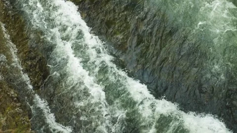 Dynamic view of the turbulent water of a rushing mountain river Stock Footage 277016361