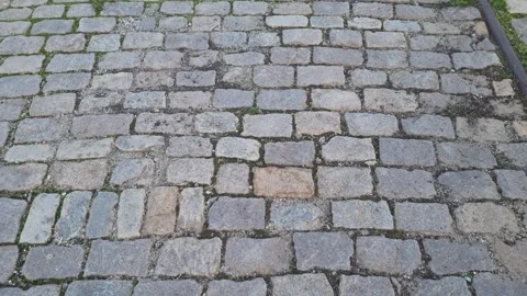 Dynamic walking view over old cobblestone pavement with natural texture Stock Footage 322019724