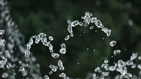 Dynamic Water Droplets Forming a Wavy Arc in Slow Motion Stock Footage 311934667