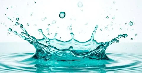 Dynamic water splash captured in mid-air, surrounded by smaller droplets against Stock Photos