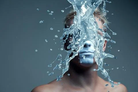 Dynamic water splash effect creating artistic portrait with frozen liquid m.. Stock Photos