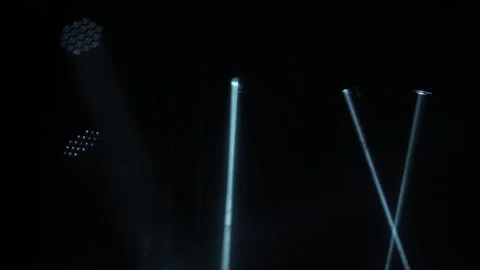 Dynamic white beams laser holograms and spotlights illuminate an empty dark Stock Footage 148410696