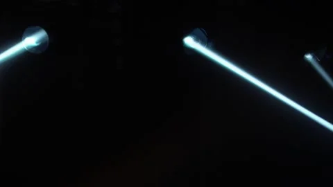 Dynamic white beams of stage light on black studio background. The searchlight 스톡 동영상 148410287