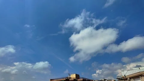 Dynamic White Clouds Moving Across Blue Sky Over Urban Landscape Timelapse 4K Stock Footage 342344326