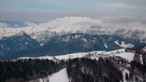 Dynamic white clouds over Bucegi Mountains in winter. Stock Footage 79554620