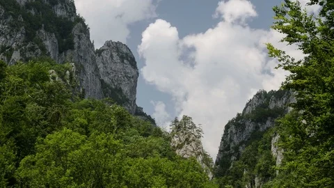 Dynamic white clouds over Buila Mountains ridge, Romania. 4k timelapse. Stock Footage 77139889