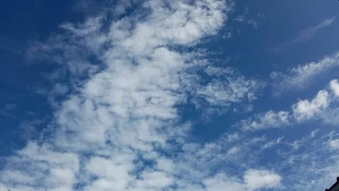 Dynamic White Clouds timelapse Scattered Across a Deep Blue Sky Stock Footage 304845746