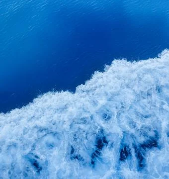 Dynamic White Foam and Waves Created by a Moving Boat. Stock Photos