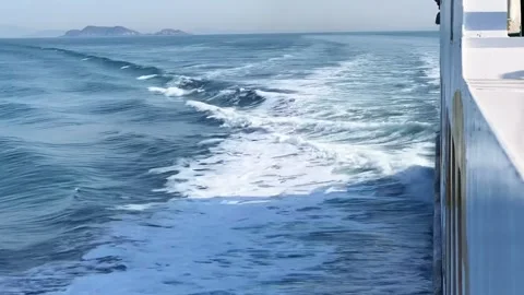 Dynamic White Wake and Foam Behind a Sailing Ship on the Blue Sea 库存影片 329921545