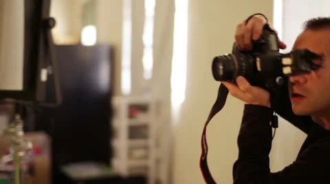 Dynamic Working Photographer Shooting and Moving with Monitor in Background Stock Footage 20606072