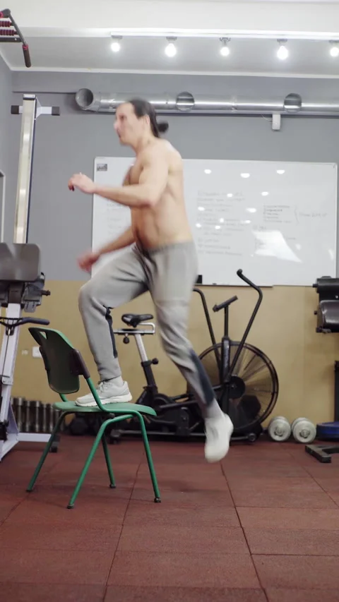 Dynamic Workout Routine Engaging Jumping Exercise Routine Performed on a Stable Stock Footage 308929733