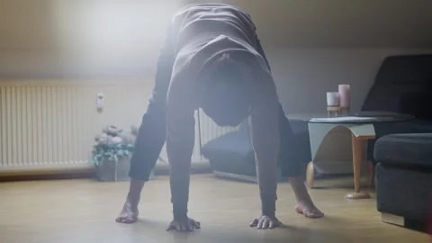 A Dynamic Workout Session at Home Featuring an Extremely Focused Individual Stock Footage 308927895