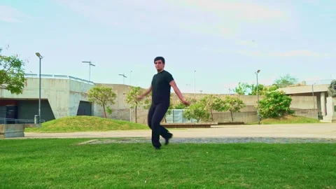 Dynamic young man dancing  in a park Video stock 304755677