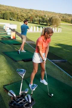 Dynamic Young Pair Enjoying Golf Game Fotos Stock