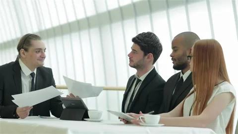 Dynamic young professionals engaged in a lively office discussion Stock Footage 311806327