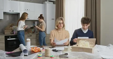 Dynamic Young Team Packaging Parcels for Small Business from Apartment Stock Photos