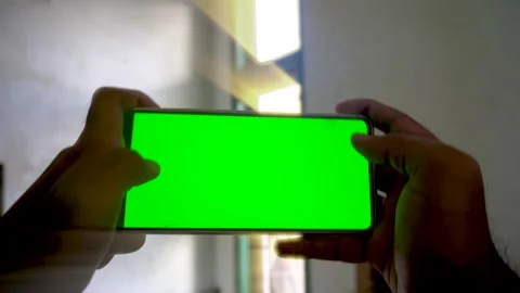 Dynamic zoom in and zoom out transition effect on a smartphone with a green.. Stock Footage 340490626