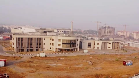 Dynamic zoom out of the NILDS office building in Abuja, Nigeria on a sunny day Stock Footage 328858606