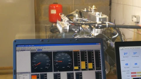 Dynamometer testing a car engine showing laptop dials Stock Footage 100757809