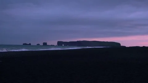 Dyrholaey cliffs at sea during ocean tide - Night time view Video stock 72325913