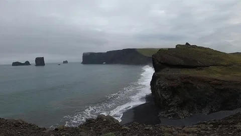Dyrholaey sea cliffs and black sand beach shoreline, Iceland Stock Footage 334570900