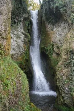 Dyserth Waterfall Cascading Down Mossy Rocks, Natural Beauty, North Wales. Stock Photos