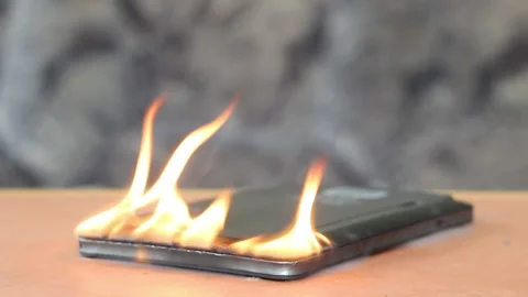 E-book caught fire due to a faulty battery on the table. Stock Footage 153795617