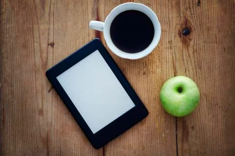 E-book reader and coffee Stock Photos