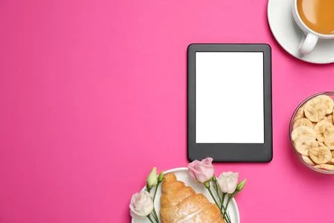 E-book reader with breakfast and flowers on pink background, flat lay. Spac.. Stock Photos