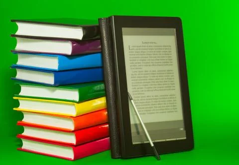 E-book reader with stack of printed books Stock Photos