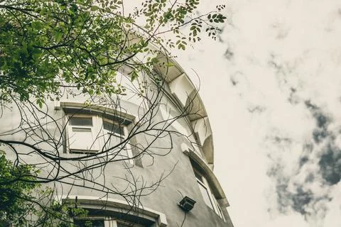 E bottom-up view concrete sky tower building medieval fortress style. Roof metal Stock Photos