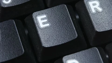 E Character or letter Key on Desktop Keyboard Pressed by Finger Hand Stock Footage 290470262