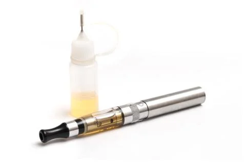 E-cigarette closeup with bottle Stock Photos