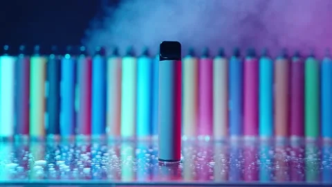 E-Cigarettes and Vapes with Smoke in Neon Lighting. Concept of Bad Habits